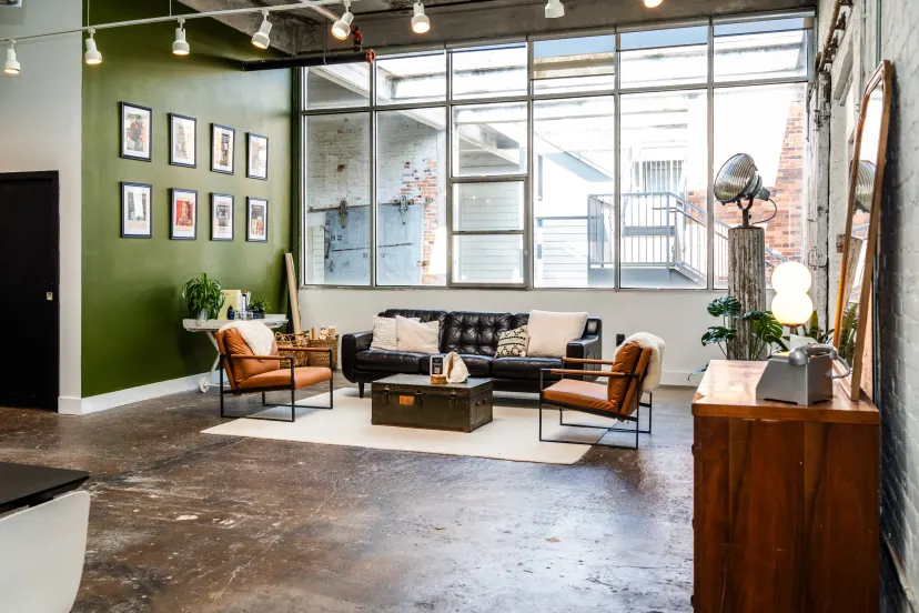 Lounge area with green accent wall and leather seating
